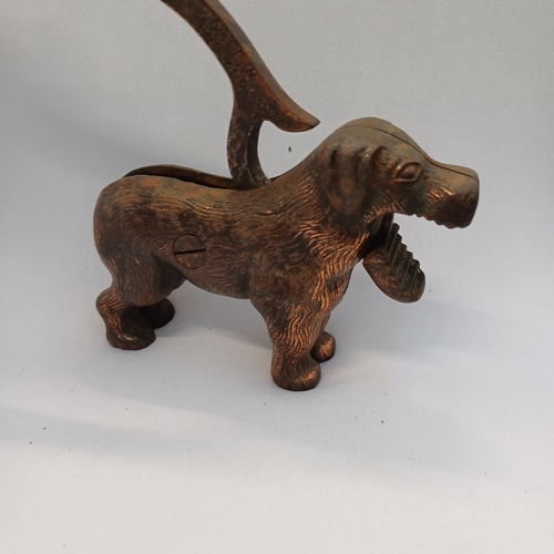 64 - 1940's Nutcracker in the shape of a dog, so when you lift his tail he opens his mouth and you push i... 