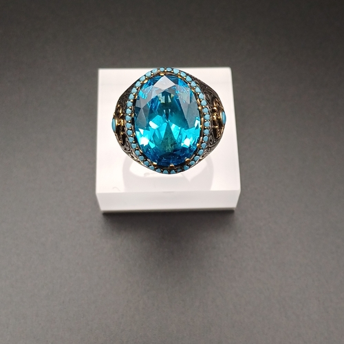 13 - Graduation Style Ottoman Gent's Ring with a Stunning Topaz Blue Stone and Turquoise set around.
- si... 