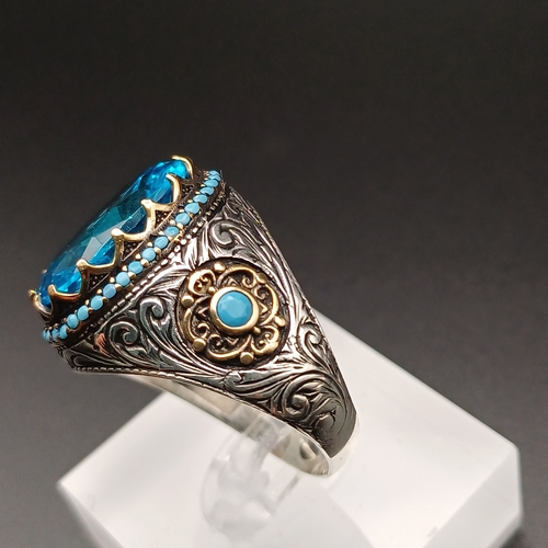 13 - Graduation Style Ottoman Gent's Ring with a Stunning Topaz Blue Stone and Turquoise set around.
- si... 