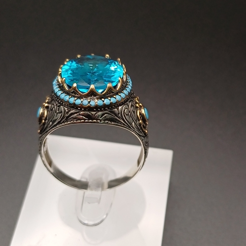 13 - Graduation Style Ottoman Gent's Ring with a Stunning Topaz Blue Stone and Turquoise set around.
- si... 