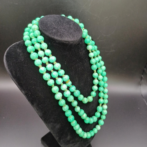 31 - Another stunning necklace of strung Jade Beads measuring 48 inches with a silver clasp and it weighs... 