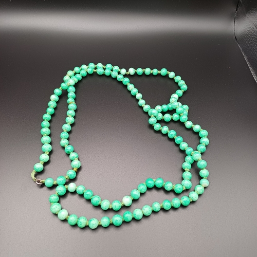 31 - Another stunning necklace of strung Jade Beads measuring 48 inches with a silver clasp and it weighs... 