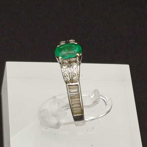 53 - This is such a beautiful coloured Emerald and enhanced by the round and baguette Diamonds set either... 