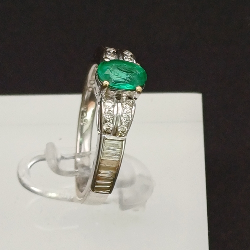 53 - This is such a beautiful coloured Emerald and enhanced by the round and baguette Diamonds set either... 