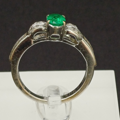 53 - This is such a beautiful coloured Emerald and enhanced by the round and baguette Diamonds set either... 