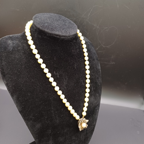 57 - Antique Single String Strand of Pearls with a Flower Pendant from Ciro of Bond Street. 
- length/dro... 