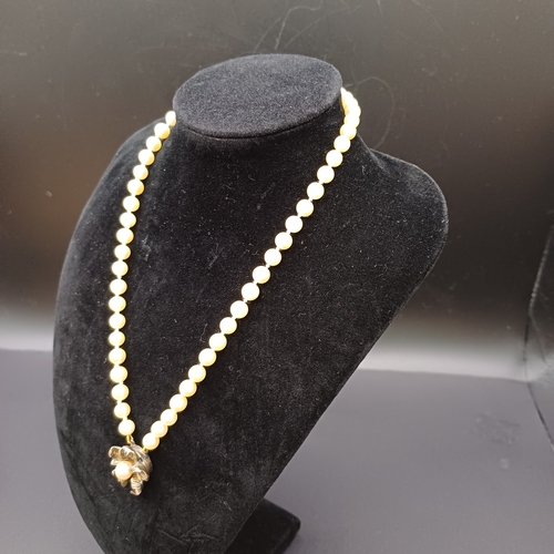 57 - Antique Single String Strand of Pearls with a Flower Pendant from Ciro of Bond Street. 
- length/dro... 