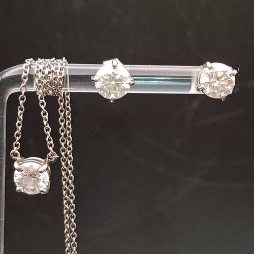 79 - Set in Platinum we have this beautiful set of Stud Earrings and Necklace all containing a one carat ...