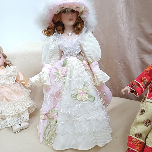 43 - Here we have three Porcelain Dolls, two on stands