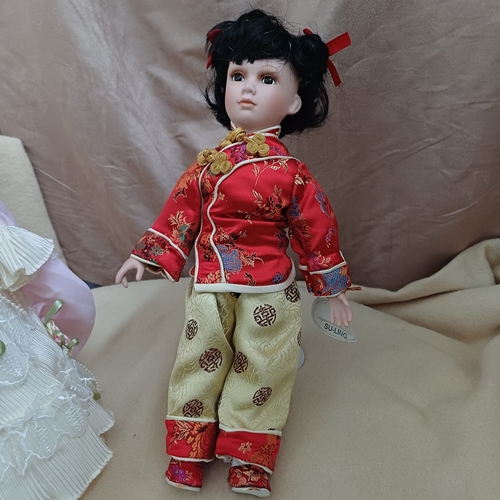 43 - Here we have three Porcelain Dolls, two on stands