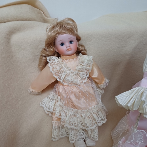 43 - Here we have three Porcelain Dolls, two on stands