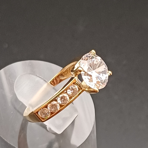 13 - CZ Solitaire Ring with further stones set each side on the shoulders.
- 14 ct
- weight 3.4 g
- size ... 