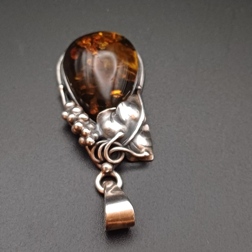 34 - A very Beautiful Amber Pendant set in 925 Silver with leaf and grape design.  The pendant is 2 inche... 