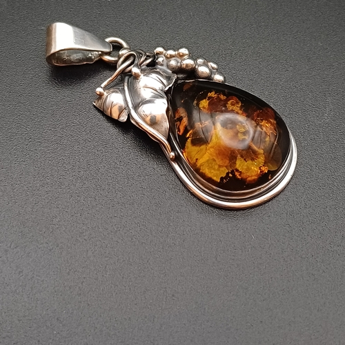 34 - A very Beautiful Amber Pendant set in 925 Silver with leaf and grape design.  The pendant is 2 inche... 