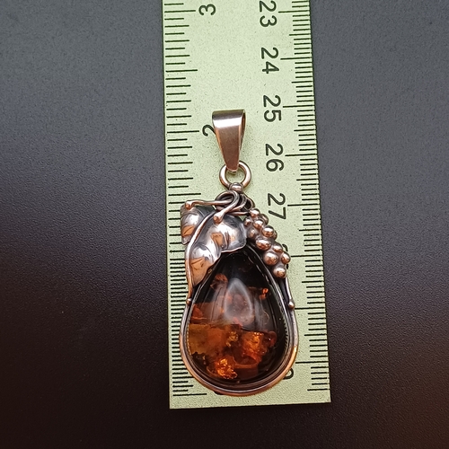 34 - A very Beautiful Amber Pendant set in 925 Silver with leaf and grape design.  The pendant is 2 inche... 