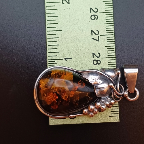 34 - A very Beautiful Amber Pendant set in 925 Silver with leaf and grape design.  The pendant is 2 inche... 