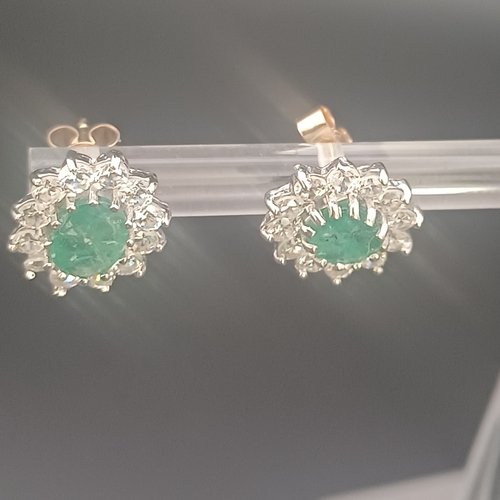 47 - Pair of Emerald and white stone stud earrings in 9ct white gold with a total weight of 2.0 g