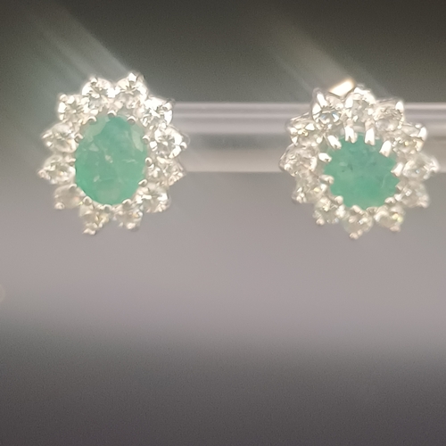 47 - Pair of Emerald and white stone stud earrings in 9ct white gold with a total weight of 2.0 g