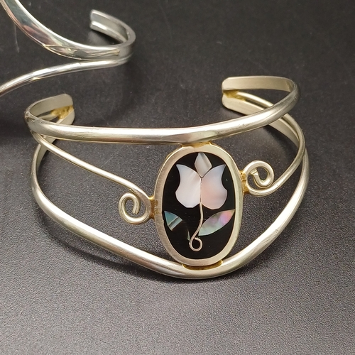 26 - Two lovely silver bangles
1. Silver metal (no hallmark) with Black Onyx detail - 22.46g
2. Silver me... 