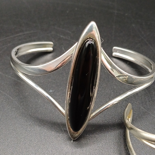 26 - Two lovely silver bangles
1. Silver metal (no hallmark) with Black Onyx detail - 22.46g
2. Silver me... 