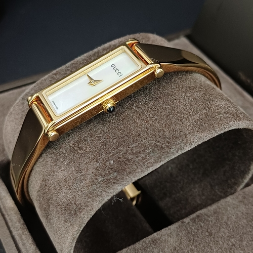 18 - Pair of Gucci Ladies Watches, both boxed with paperwork:
1.  Gucci 6800L - Silver Metal Face and Ban... 