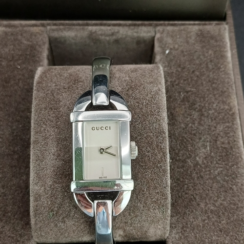 18 - Pair of Gucci Ladies Watches, both boxed with paperwork:
1.  Gucci 6800L - Silver Metal Face and Ban... 