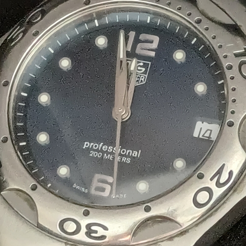 24 - TAG Heuer Professional WL111F TT5456 .  A 37mm case houses a quartz movement and features a bule dia... 