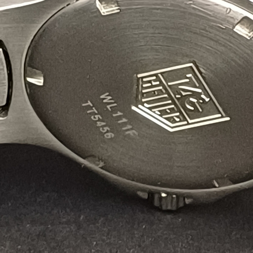 24 - TAG Heuer Professional WL111F TT5456 .  A 37mm case houses a quartz movement and features a bule dia... 
