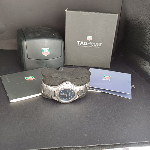 24 - TAG Heuer Professional WL111F TT5456 .  A 37mm case houses a quartz movement and features a bule dia... 