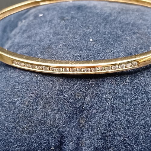 43 - Diamond Hinge Bangle set in 14 carat yellow gold weighing 8.65g