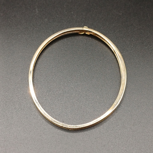 43 - Diamond Hinge Bangle set in 14 carat yellow gold weighing 8.65g