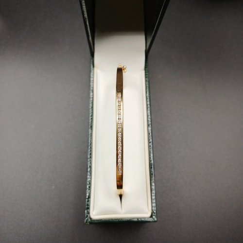 43 - Diamond Hinge Bangle set in 14 carat yellow gold weighing 8.65g
