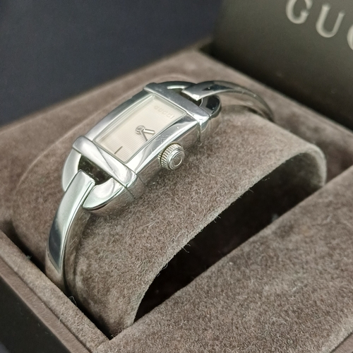 53 - Pair of Gucci Ladies Watches, both boxed with paperwork:
1.  Gucci 6800L - Silver Metal Face and Ban... 