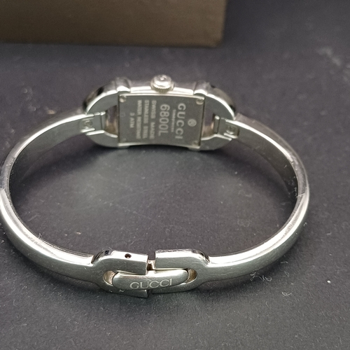 53 - Pair of Gucci Ladies Watches, both boxed with paperwork:
1.  Gucci 6800L - Silver Metal Face and Ban... 