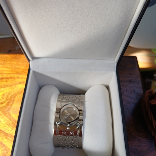 57 - Ladies Gucci Twirl Bangle Watch.  This is in excellent condition and all boxed with paperwork.