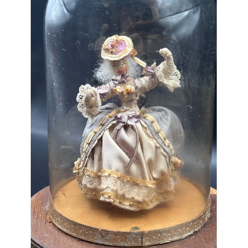 118 - Louis Vuitton. This vintage music box automaton features a miniature doll under a glass dome and is ... 