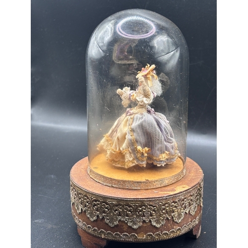 118 - Louis Vuitton. This vintage music box automaton features a miniature doll under a glass dome and is ... 