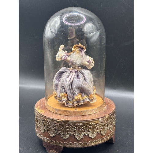 118 - Louis Vuitton. This vintage music box automaton features a miniature doll under a glass dome and is ... 