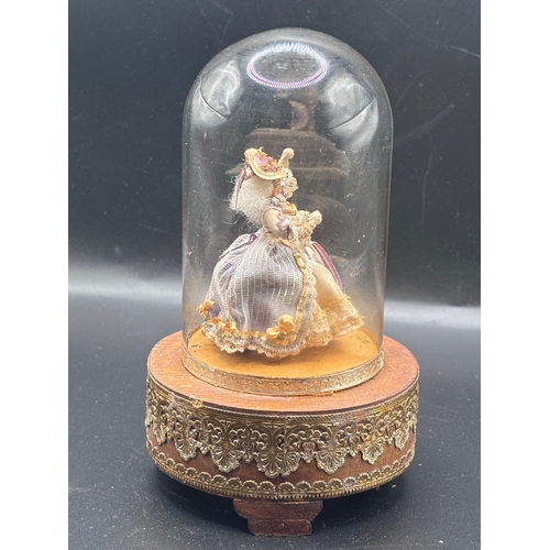 118 - Louis Vuitton. This vintage music box automaton features a miniature doll under a glass dome and is ... 