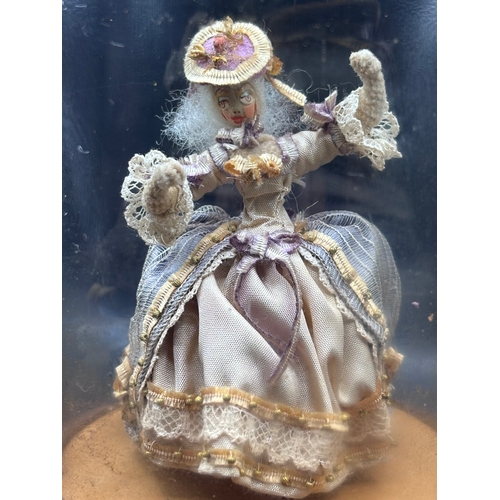 118 - Louis Vuitton. This vintage music box automaton features a miniature doll under a glass dome and is ... 