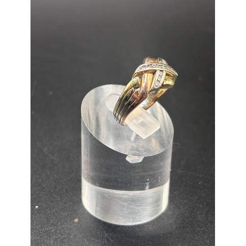13 - 9ct yellow gold with diamond cluster in the style of a puzzle ring.
Size K / L: Weight 4.6g