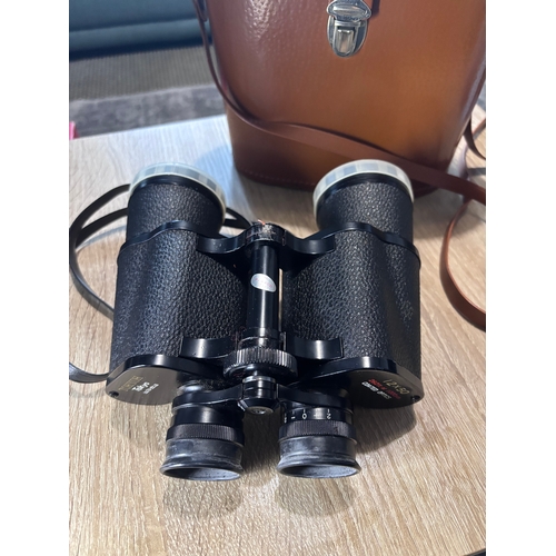 82 - This item is a pair of vintage Hyoh Tokyo 12x50 binoculars, featuring coated optics and a field of v... 