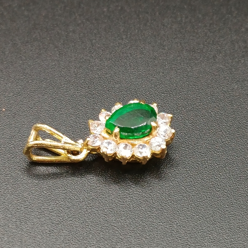 21 - Very pretty Pear Shaped Emerald set in 18 carat yellow gold with white stones set around weighing 3.... 