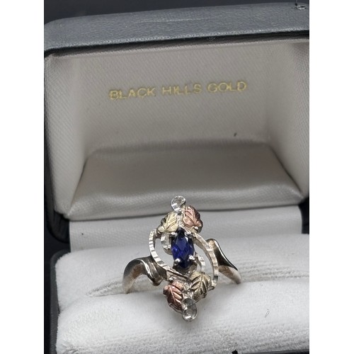 27 - Black Hills Gold ring, crafted in silver with signiture tri gold  leaf motifs, 10k yellow gold and r... 