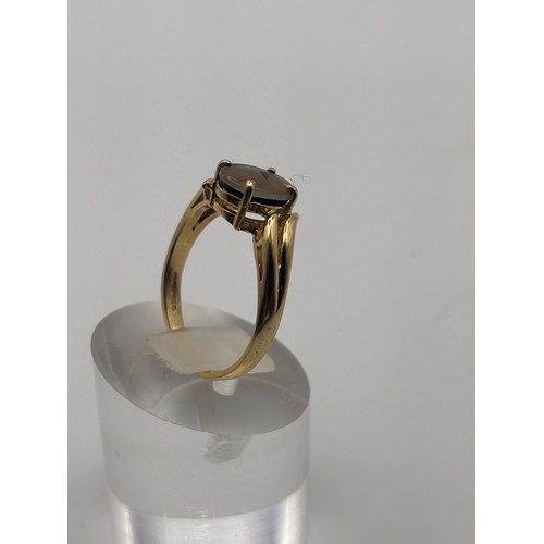 36 - 14ct yellow gold ring with natural ammolite gemstone.
Weigh 3.22g
P/q