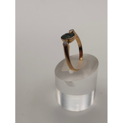 38 - 14ct yellow gold dark green gem flanked by smaller opal gemstones. 
Weighs 4.36g
Size r