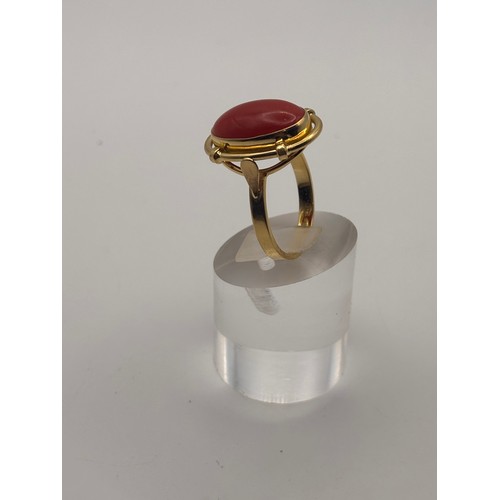 35 - 18ct yellow gold cabochan cut red coral in ornate setting.
Weighs 6.67g

Size p/q