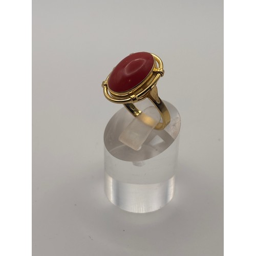 35 - 18ct yellow gold cabochan cut red coral in ornate setting.
Weighs 6.67g

Size p/q