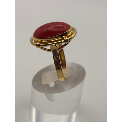 35 - 18ct yellow gold cabochan cut red coral in ornate setting.
Weighs 6.67g

Size p/q