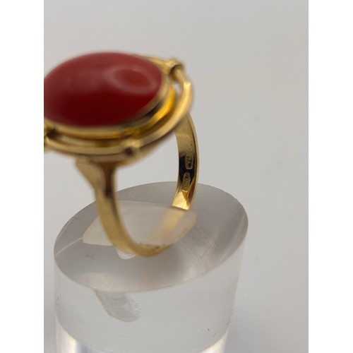 35 - 18ct yellow gold cabochan cut red coral in ornate setting.
Weighs 6.67g

Size p/q